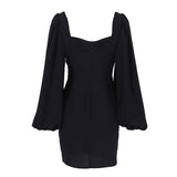 Back view of a black mini dress with puff sleeves