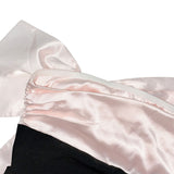 close-up detail of the satin bow and zipper on the dress