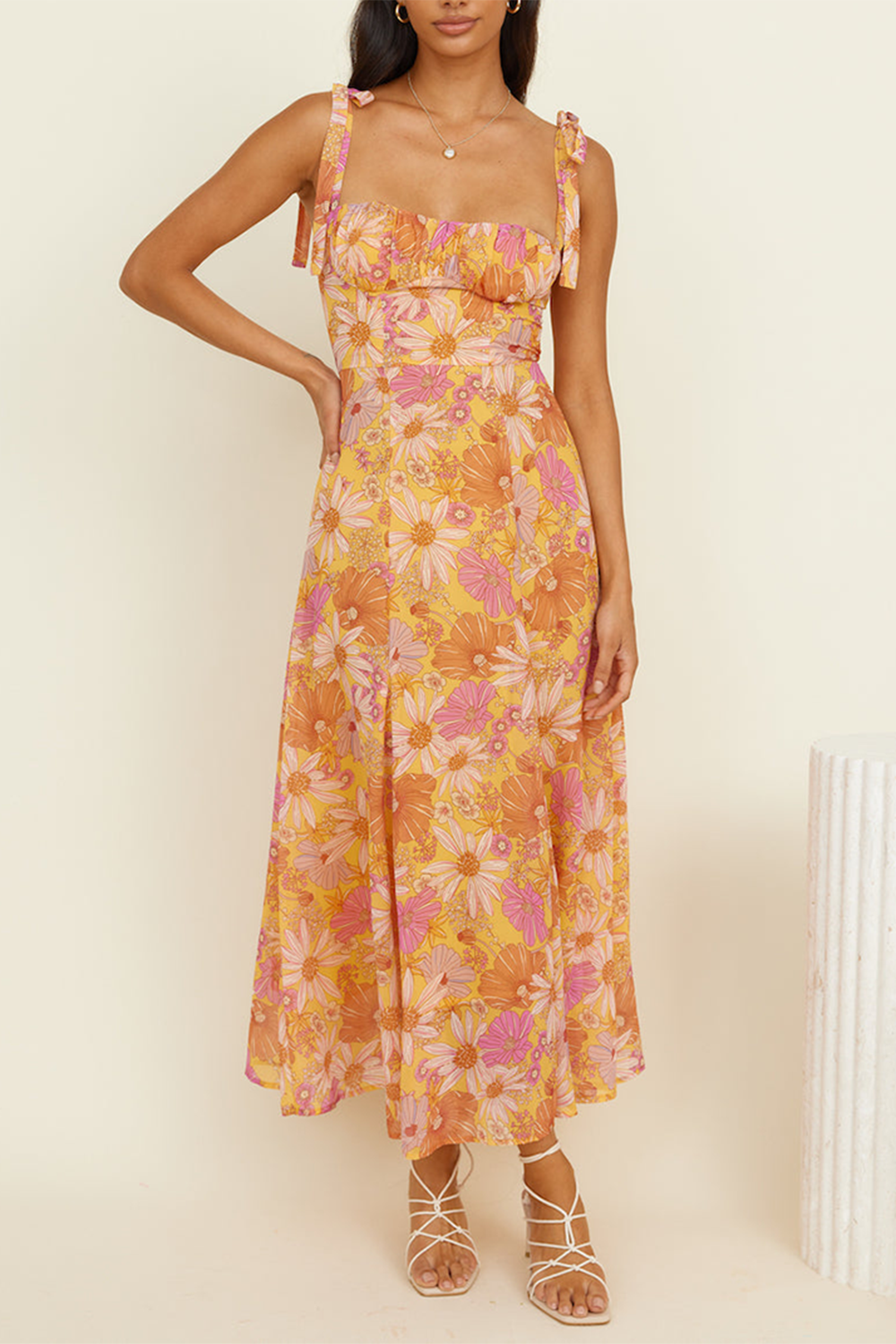 woman in a floral print midi dress with hands on hips, showcasing the A-line silhouette