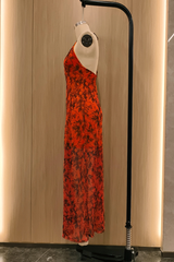 side view of an orange floral print maxi dress on a mannequin