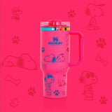 Stanley 40oz insulated tumbler featuring Snoopy illustrations, blue paw prints and bone icons, white body with white ergonomic handle