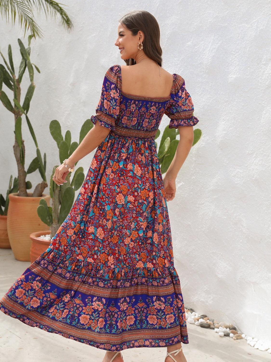 Woman in a blue floral off-the-shoulder maxi dress, showing the back view and spinning.