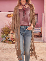 woman wearing a brown lace kimono over a dusty rose top and blue jeans