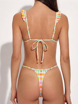 back view of a woman in a colorful gingham print bikini set with tie closure