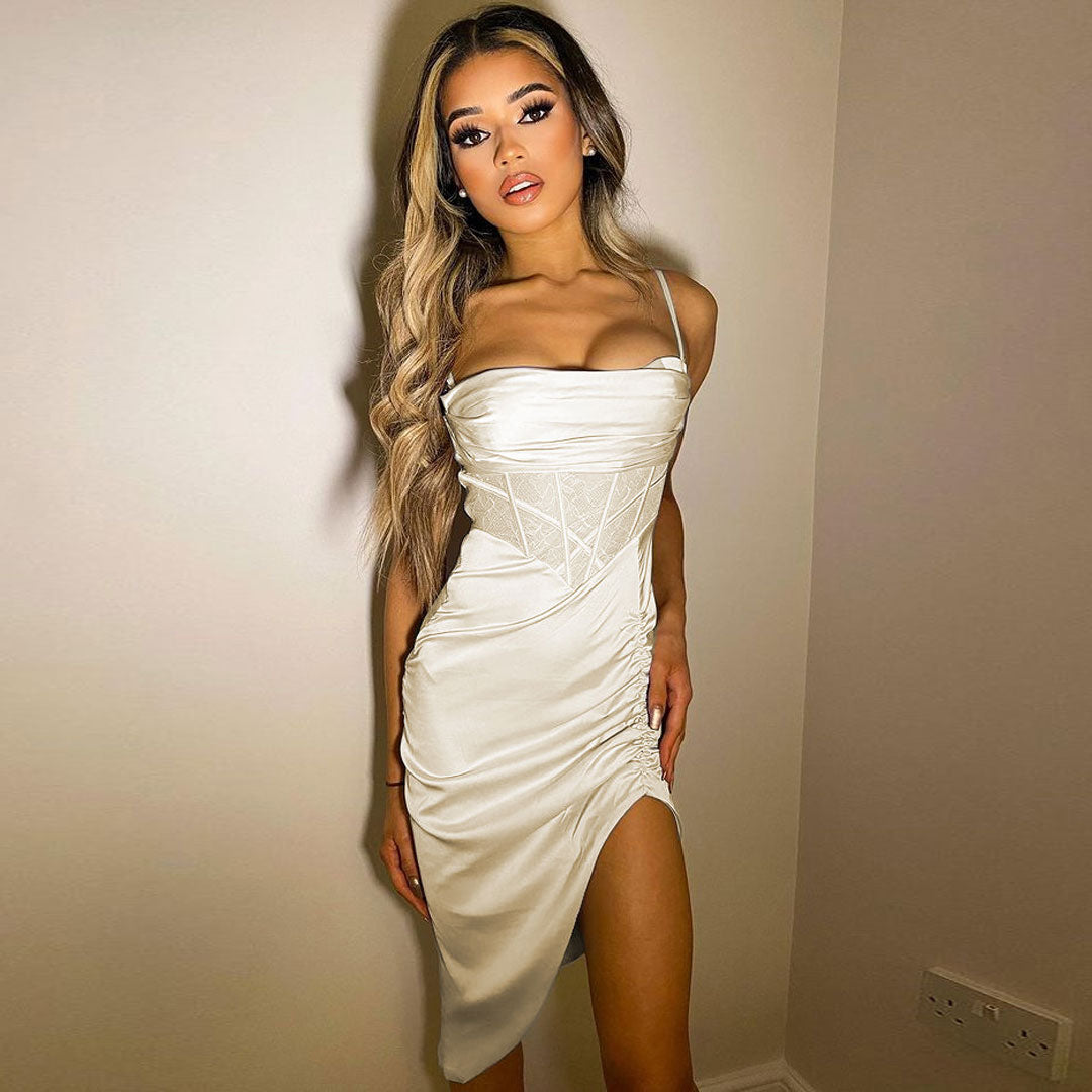 woman wearing a white ruched satin dress with a lace bodice and asymmetrical hem