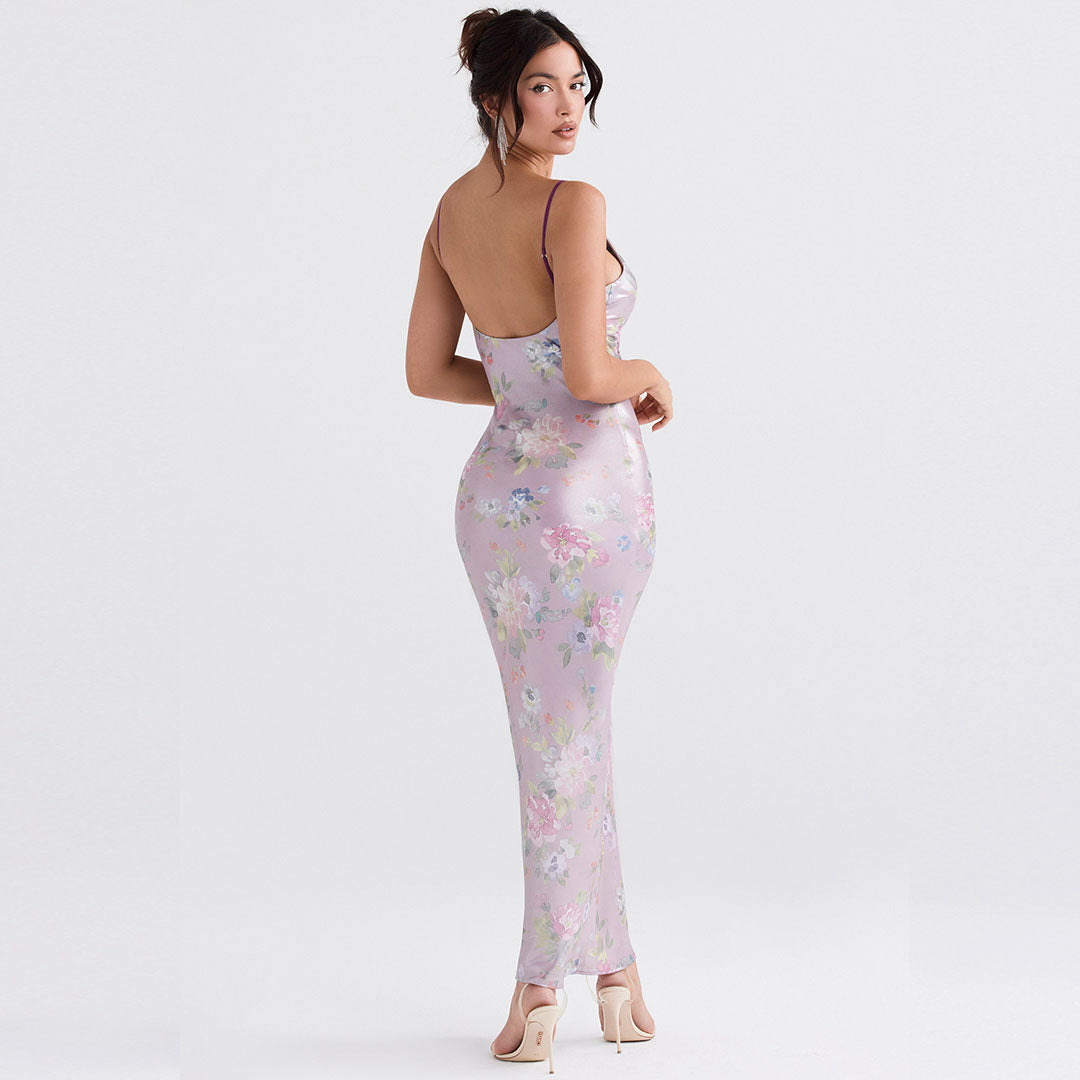 Back view of a woman in a floral print slip dress, highlighting the low back and maxi length.