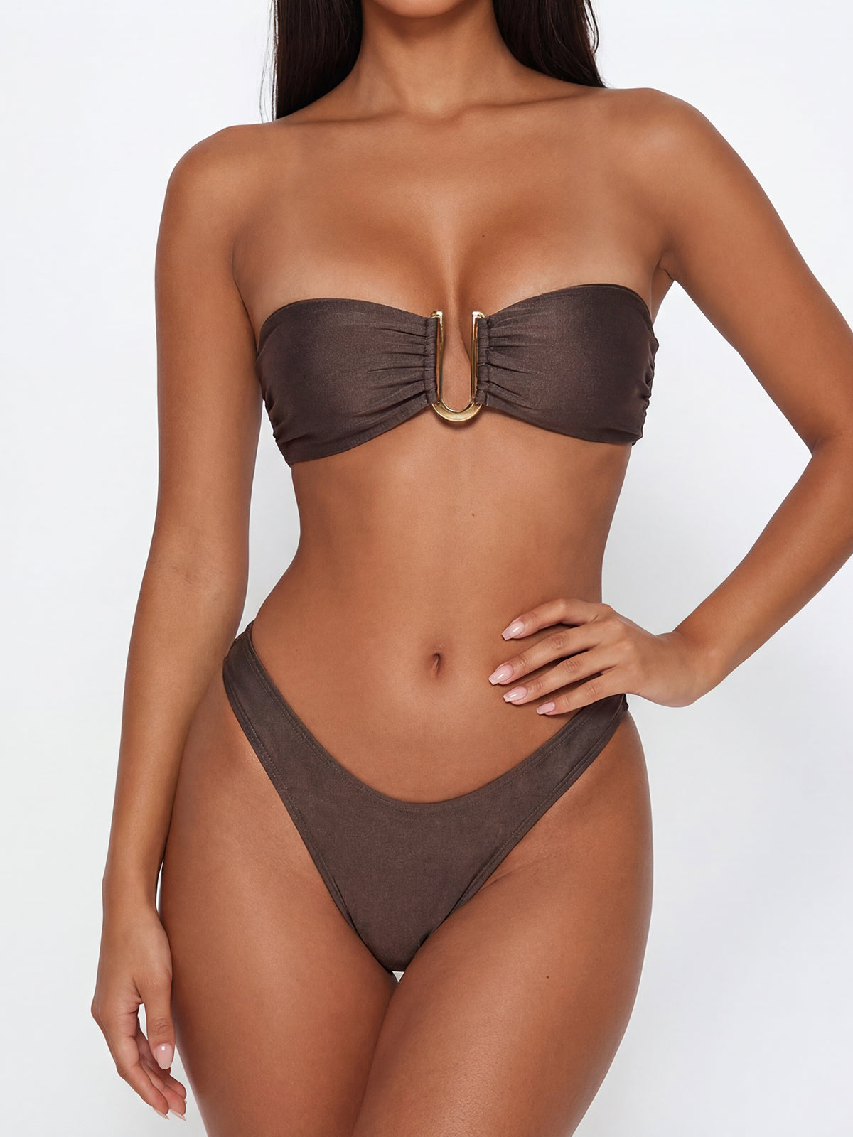 Woman wearing a brown strapless bikini with gold hardware