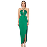 woman wearing a green satin halter neck maxi dress with cut-out details and a high slit, front view