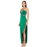 woman wearing a green satin halter neck maxi dress with cut-out details and a high slit, side view