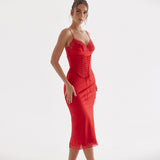 Side view of woman in red satin sheath dress with lace trim