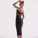 Side view of a black midi sheath dress with lace bodice and floral embellishment