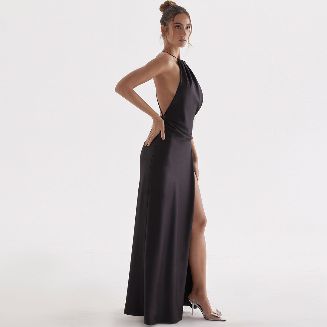 side view of a woman in a black formal gown with a high slit