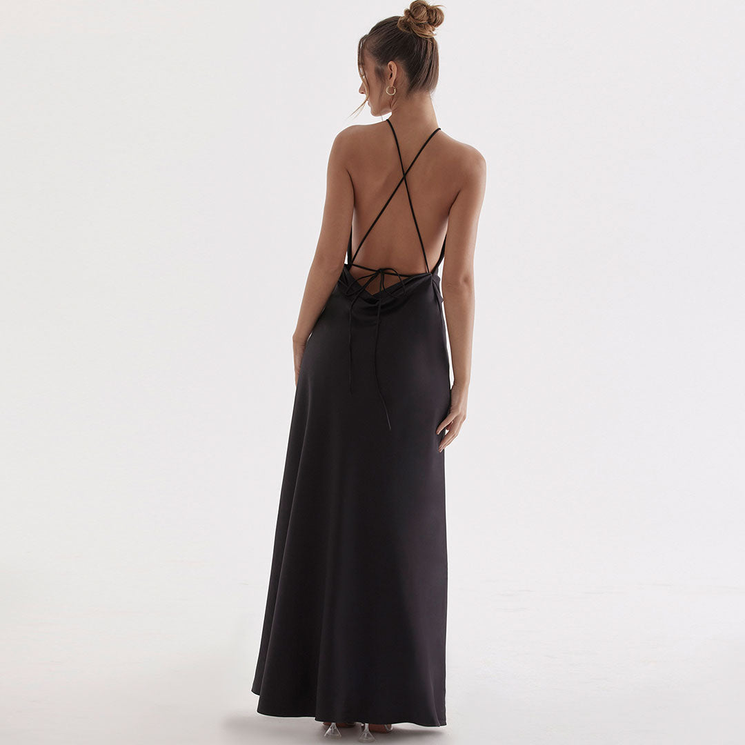 back view of a woman in a black open-back halter dress