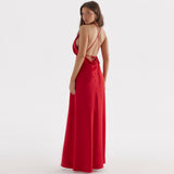 Back view of a woman in a long red satin dress with an open back and criss-cross straps.
