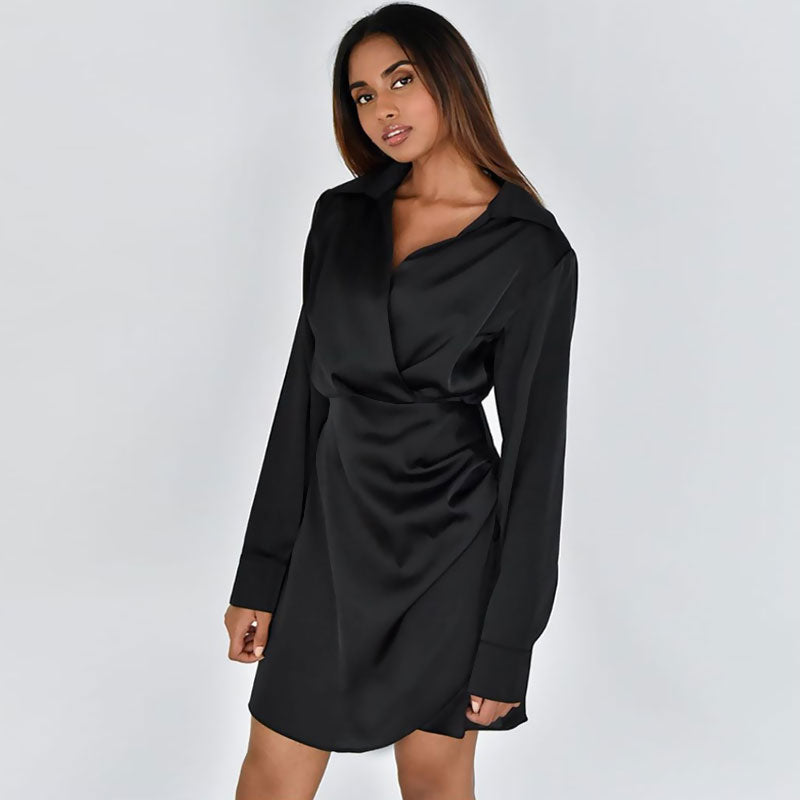 woman wearing a black satin wrap dress with long sleeves and a collared neckline