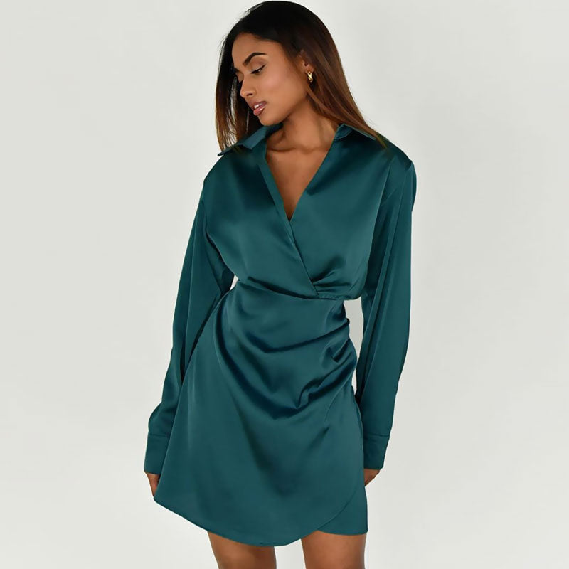 Woman wearing a teal satin long sleeve wrap mini dress from the front