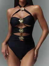 Black one-piece swimsuit with gold floral accents and cut-outs