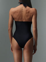 Back view of black one-piece swimsuit