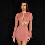 Woman wearing a pink long-sleeved mini dress with cut-out details