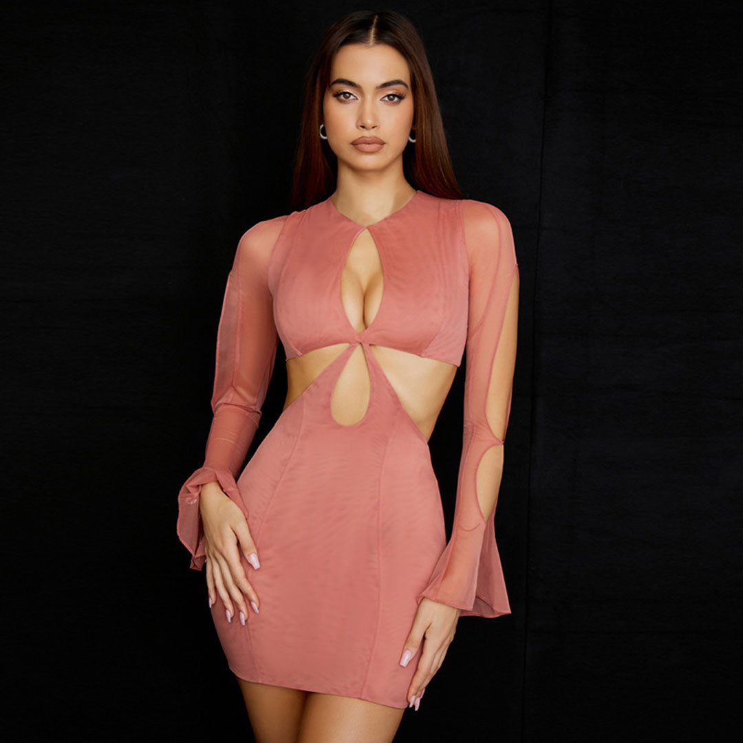 Close-up of a woman in a pink dress featuring a keyhole neckline and cut-outs
