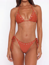 Rust-colored bikini top and bottom with grommet detail, front view