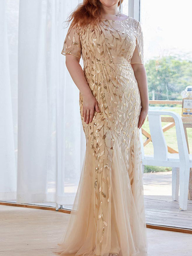 Close-up of the sequined leaf pattern on a gold formal dress.