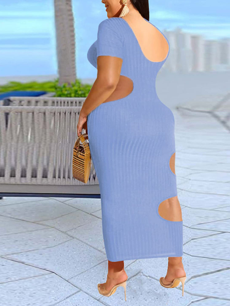 Back view of a woman in a light blue midi dress with cut-out details.