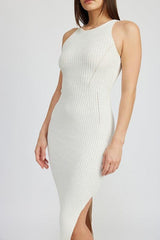 Close-up of a white ribbed knit midi dress on a woman, highlighting the texture and fit.
