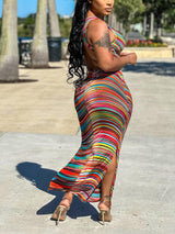 Back view of a woman in a multicolored striped maxi dress.