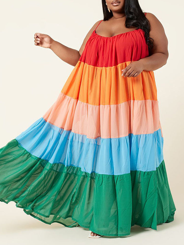 Plus size woman wearing a colorful tiered maxi dress with spaghetti straps.