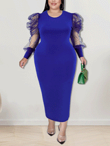 Woman wearing a royal blue sheath dress with sheer puff sleeves
