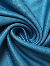 Swirled satin fabric in a teal color