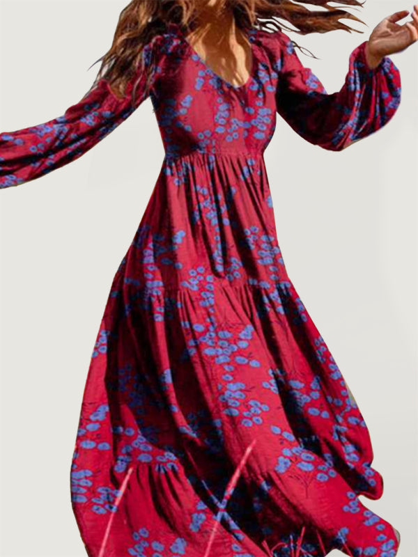 Woman wearing a long red floral maxi dress with bell sleeves outdoors.
