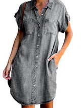 woman wearing a gray denim short-sleeve shirt dress with a collared neckline and button-down front
