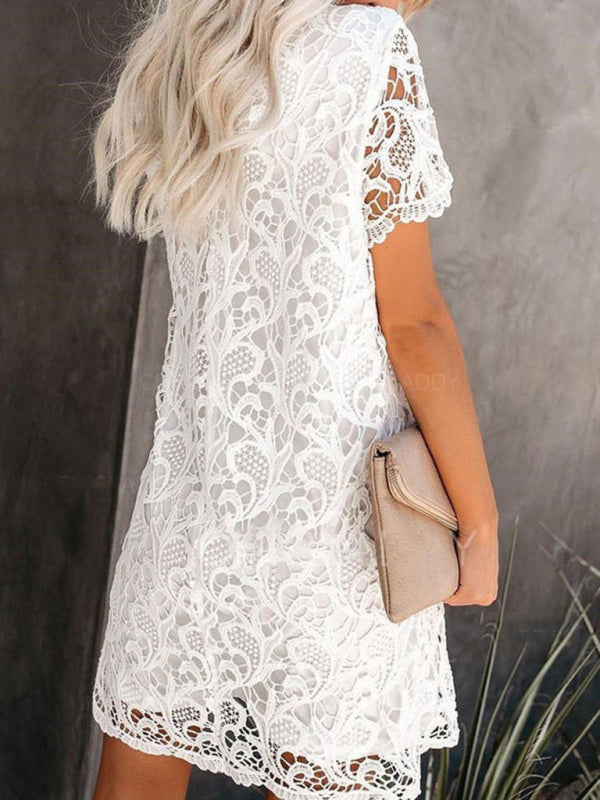 back view of a woman wearing a white lace mini dress
