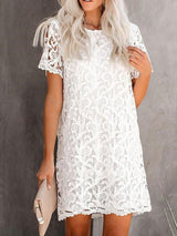 front view of a woman wearing a white lace mini dress with short sleeves
