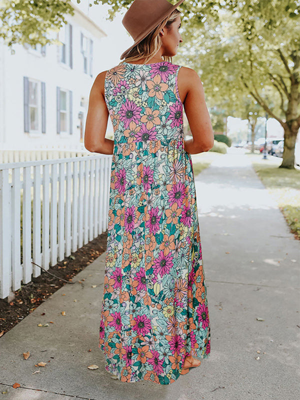 Woman wearing a floral print sleeveless maxi dress with pockets, back view