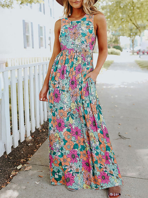 Woman wearing a floral print sleeveless maxi dress with pockets, front view