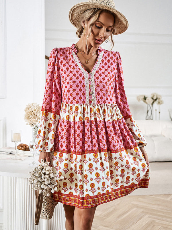 Back view of a woman wearing a pink and white floral print tiered mini dress.
