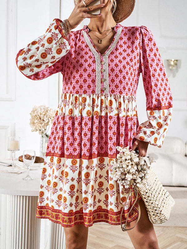 Close-up of the front of a tiered mini dress with floral print and button details.