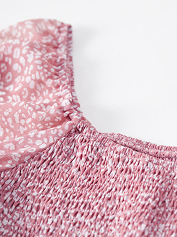 Close-up of the smocked bodice and neckline of the pink floral dress.
