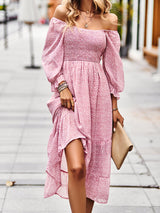 Woman wearing a pink floral off-the-shoulder maxi dress with puff sleeves and a smocked bodice.