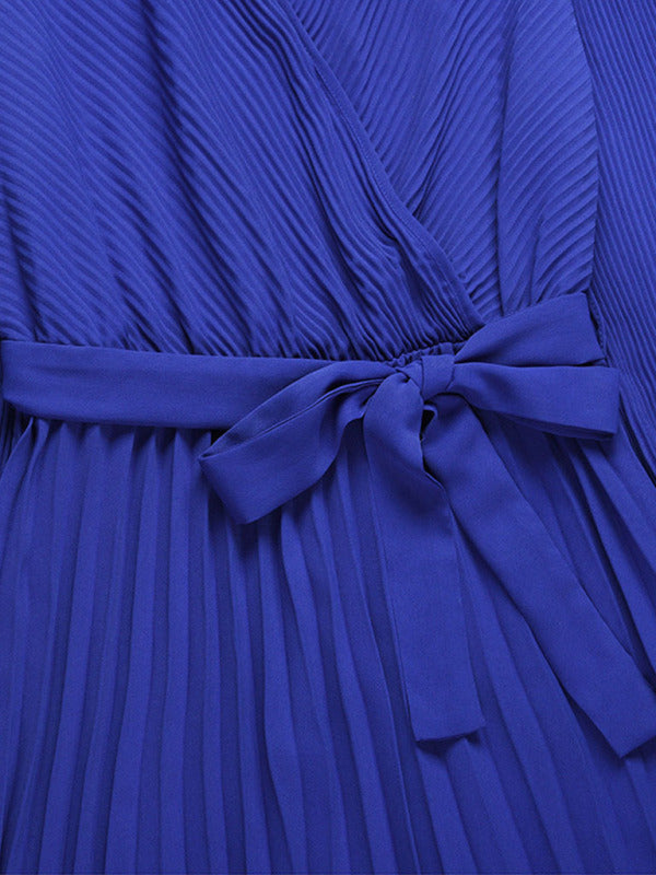 close-up of the tie waist and pleated fabric of a blue dress