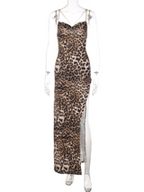 Front view of a leopard print maxi dress with a high slit and chain detail straps.