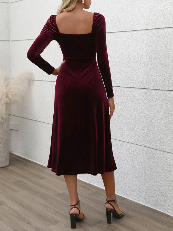 Back view of a woman wearing a long-sleeved, wine-colored velvet midi dress with a sweetheart neckline and a high slit.
