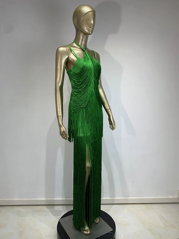 side view of a mannequin wearing a long green halter neck dress with tiered fringe and a high leg slit