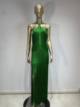 mannequin wearing a long green halter neck dress with tiered fringe and a high leg slit