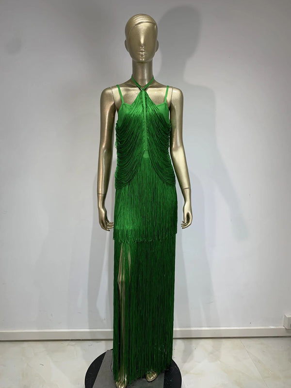 mannequin wearing a long green halter neck dress with tiered fringe and a high leg slit