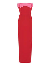 Front view of a red strapless midi dress with a pink bow accent.