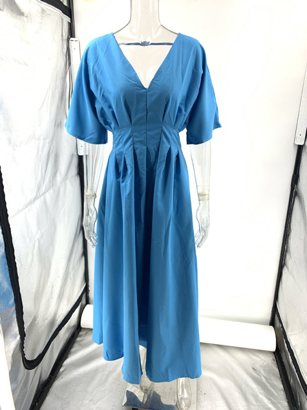 Front view of a blue dolman sleeve midi dress on a mannequin, highlighting the V-neckline and pleated skirt.
